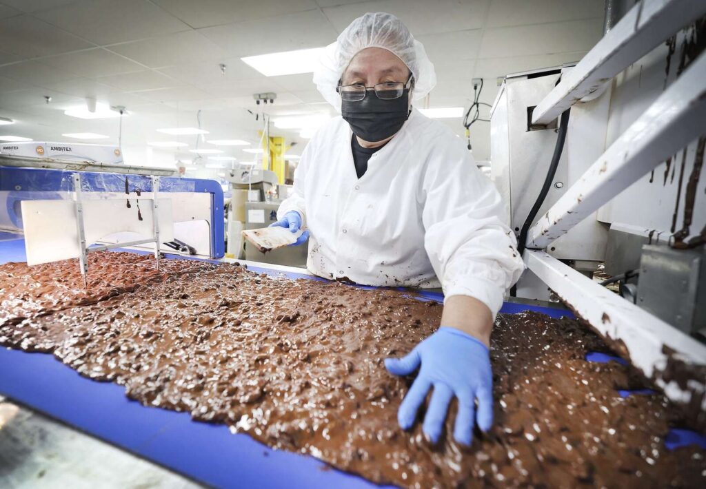 Birthday cake truffles being pulled from Rocky Mountain Chocolate Factory shelves